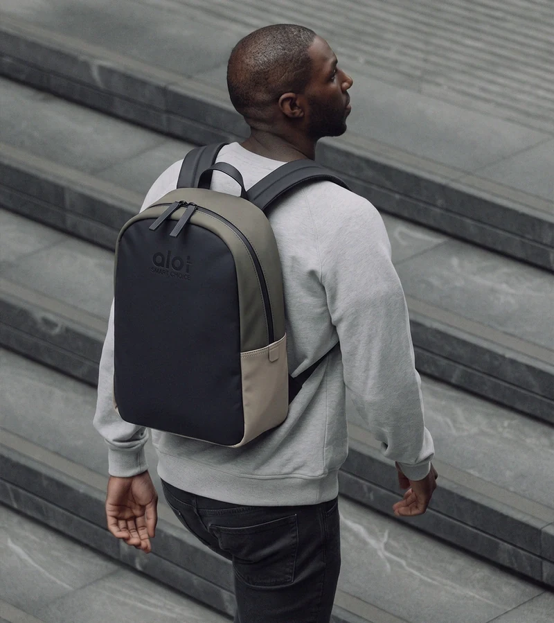 An ALOT backpack on the shoulder at the stairs