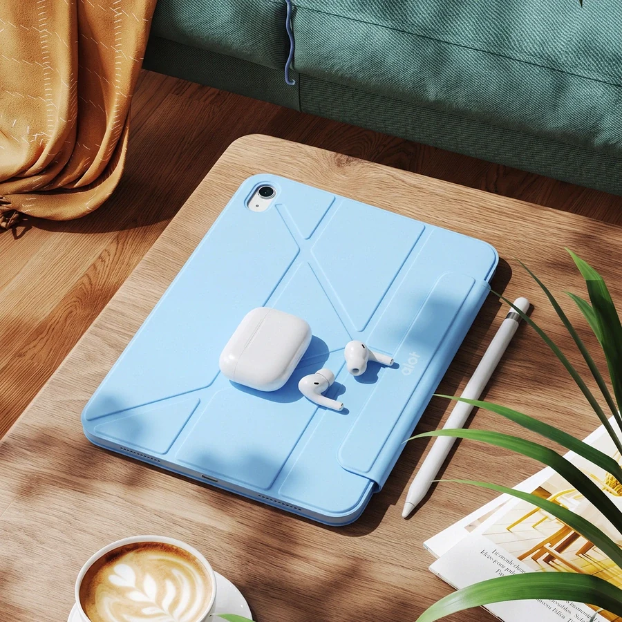 An ALOT iPad case on a desk beside a coffee